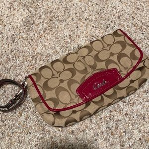 Beige with red piping Coach wristlet.